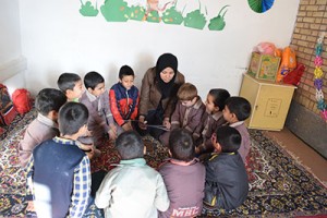 A tutor reads aloud with children - Read with Me in South Khorasan - Jan 2016