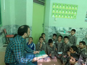 A tutor reads aloud with children - Read with Me in South Khorasan - Jan 2016