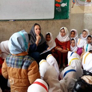 A trainer reads aloud with children - Read with Me in Zabol - Jan 2016