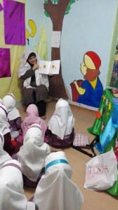 A tutor reads aloud with children - Read with Me in Zahedan - Jan 2016