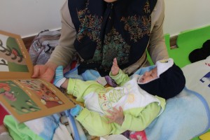 A Mother reading with her baby in babies and toddlers workshop - Read with Me in MahmoodAbad, Tehran - Jan 2016
