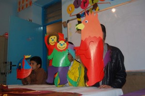 Children playing with masks made by themselves from book characters - Read with Me in Sistan and Balouchestan - Marhc 2016