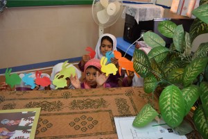 Children playing with finger puppets of book characters - Read with Me in Boshrouyeh - April 2016