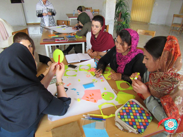 Participants learning book-related artistic activities