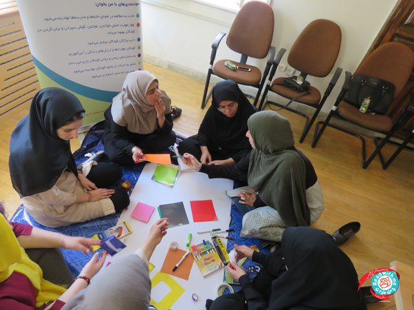 Participants learning book-related artistic activities